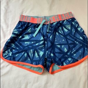 Size small pattered light and dark blue with orange under armor shorts